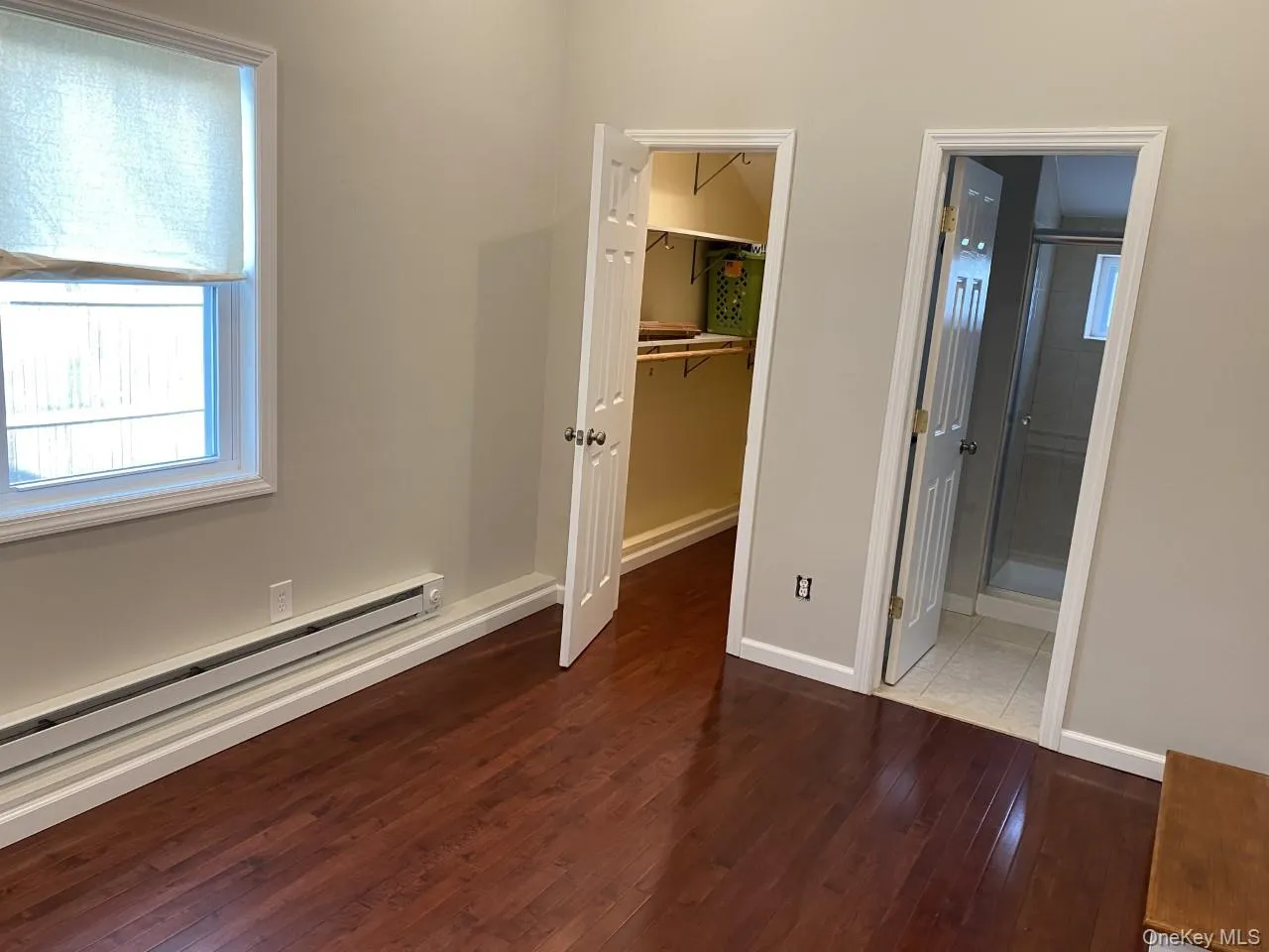 Bedroom or den with wood finished floors, a walk in closet, and Bathroom Bedroom or den with wood finished floors, a walk in closet, and Bathroom