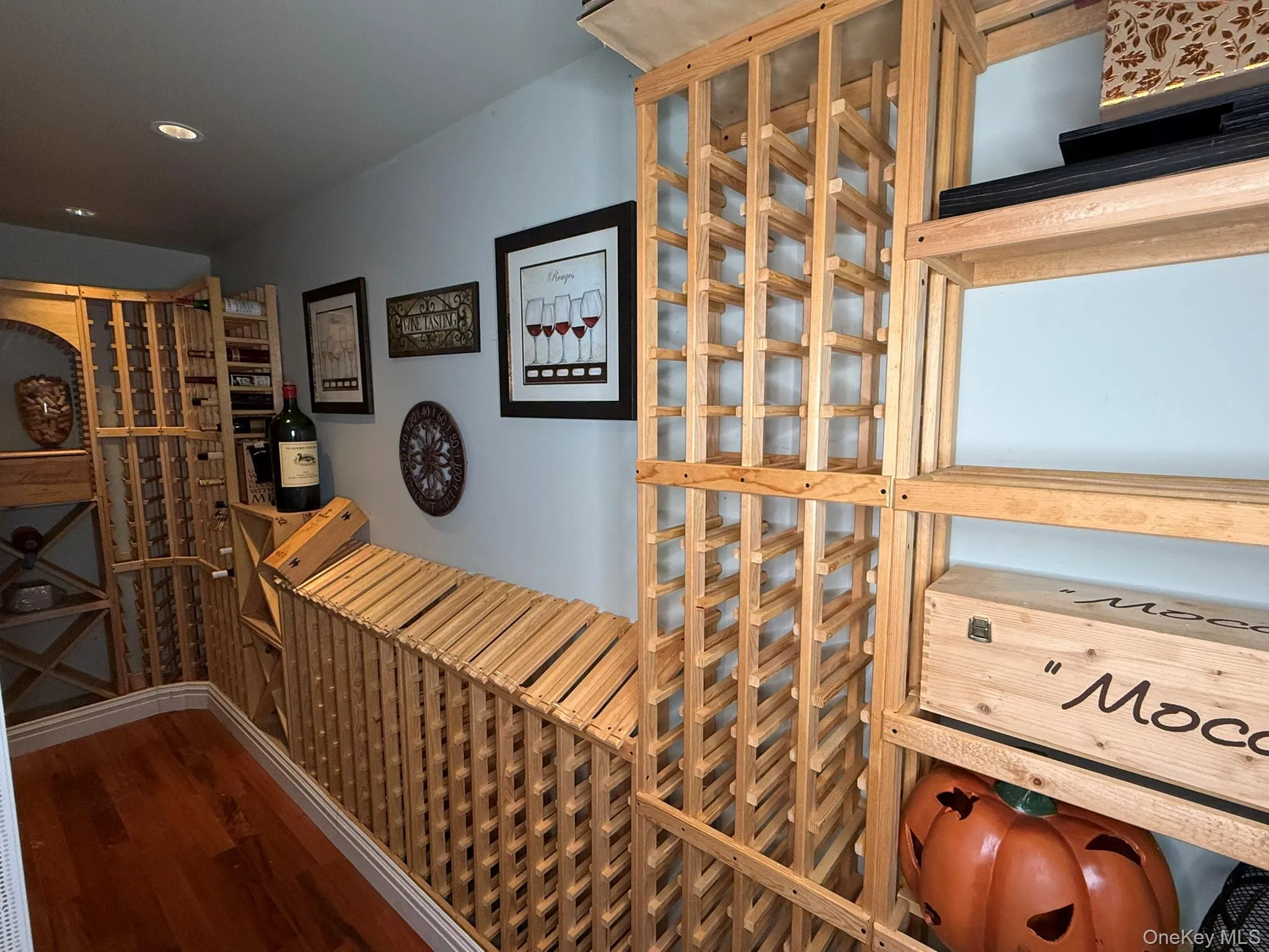Wine cellar with dark wood-style flooring and recessed lighting Wine cellar with dark wood-style flooring and recessed lighting