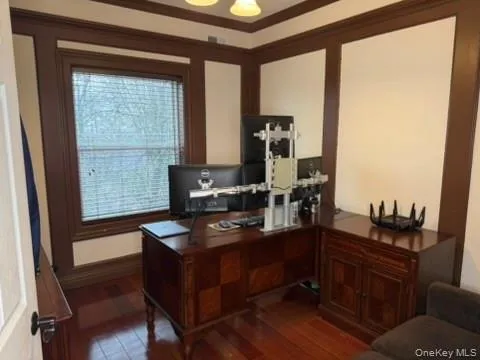 Office area featuring dark wood-style floors and a chandelier Office area featuring dark wood-style floors and a chandelier