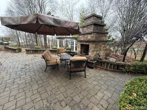 View of patio / terrace with an outdoor living space with a stone fire pit View of patio / terrace with an outdoor living space with a stone fire pit