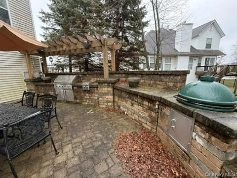 View of patio featuring an outdoor kitchen and a pergola View of patio featuring an outdoor kitchen and a pergola