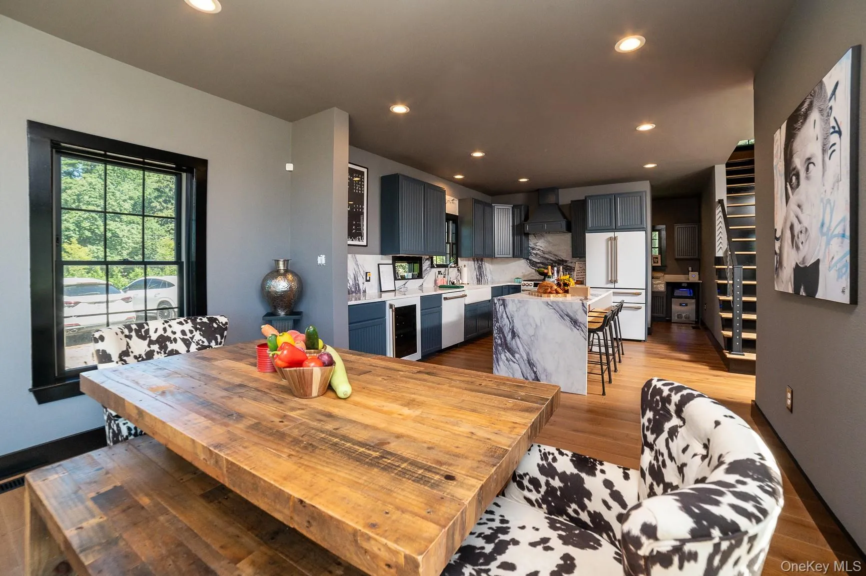 Dining room featuring light wood-style flooring, wine cooler, and recessed lighting Dining room featuring light wood-style flooring, wine cooler, and recessed lighting