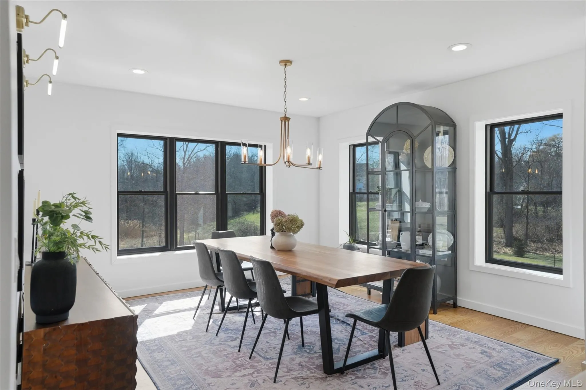 Sun drenched living room off the kitchen with elegant light fixture. Sun drenched living room off the kitchen with elegant light fixture.