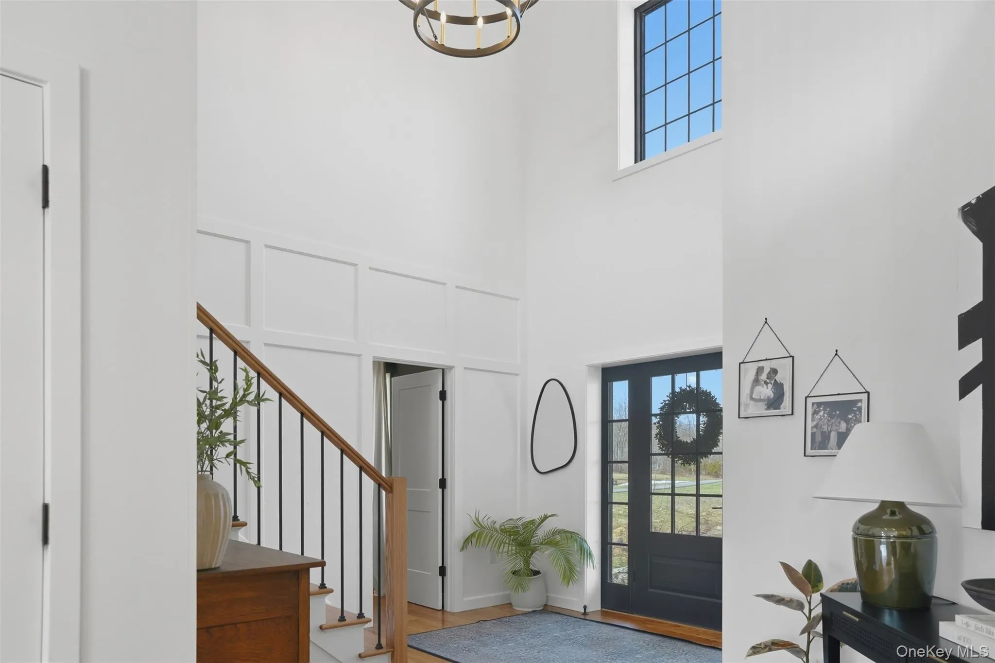 Soaring ceilings, thoughtfully selected light fixtures and board and batten wall add a beautiful richness to the foyer Soaring ceilings, thoughtfully selected light fixtures and board and batten wall add a beautiful richness to the foyer