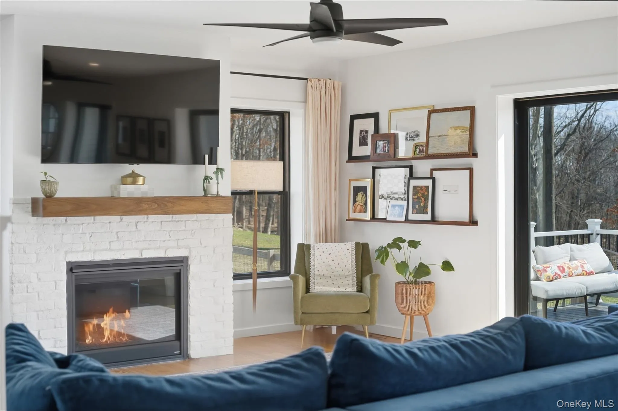 A gas fireplace is the focal point in the spacious, open concept living room. Large glass doors out to the composite floating deck allow for great flow when entertaining. A gas fireplace is the focal point in the spacious, open concept living room. Large glass doors out to the composite floating deck allow for great flow when entertaining.