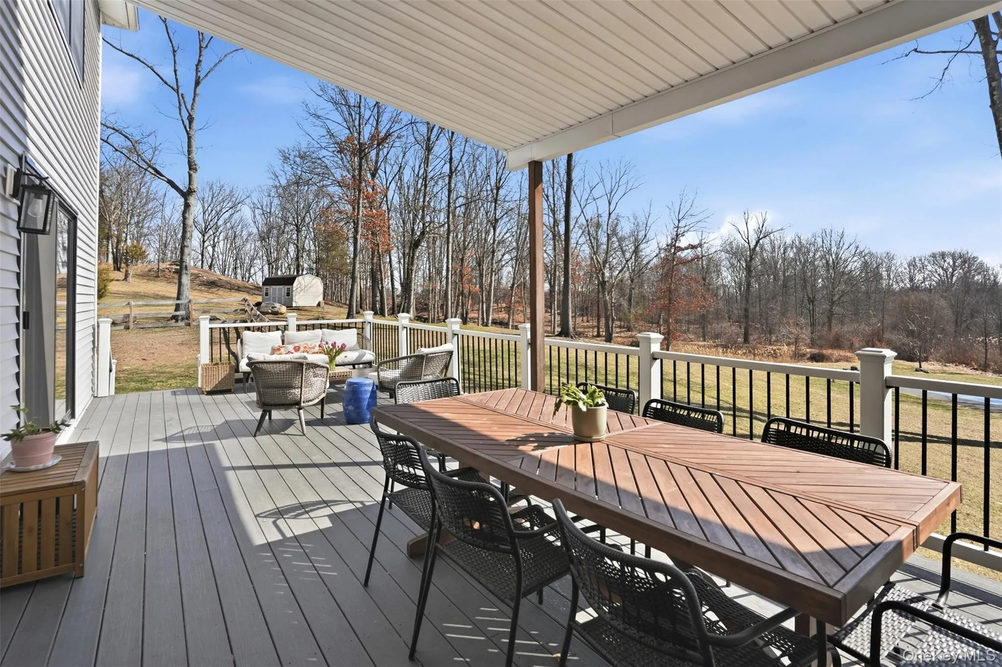 A composite deck with overhang for shade and ceiling fan make this a comfortable extension of living space, outdoors. Overlooking the 1.9 acres, retention pond and pickleball court. A composite deck with overhang for shade and ceiling fan make this a comfortable extension of living space, outdoors. Overlooking the 1.9 acres, retention pond and pickleball court.