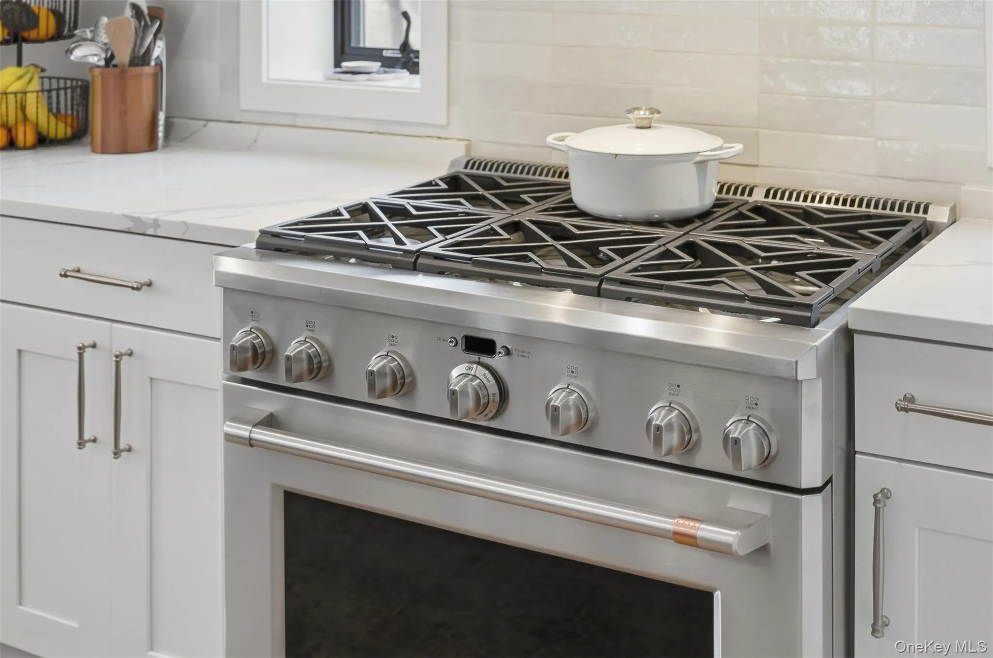 The kitchen features cafe series appliances including a gas stove and wine fridge The kitchen features cafe series appliances including a gas stove and wine fridge