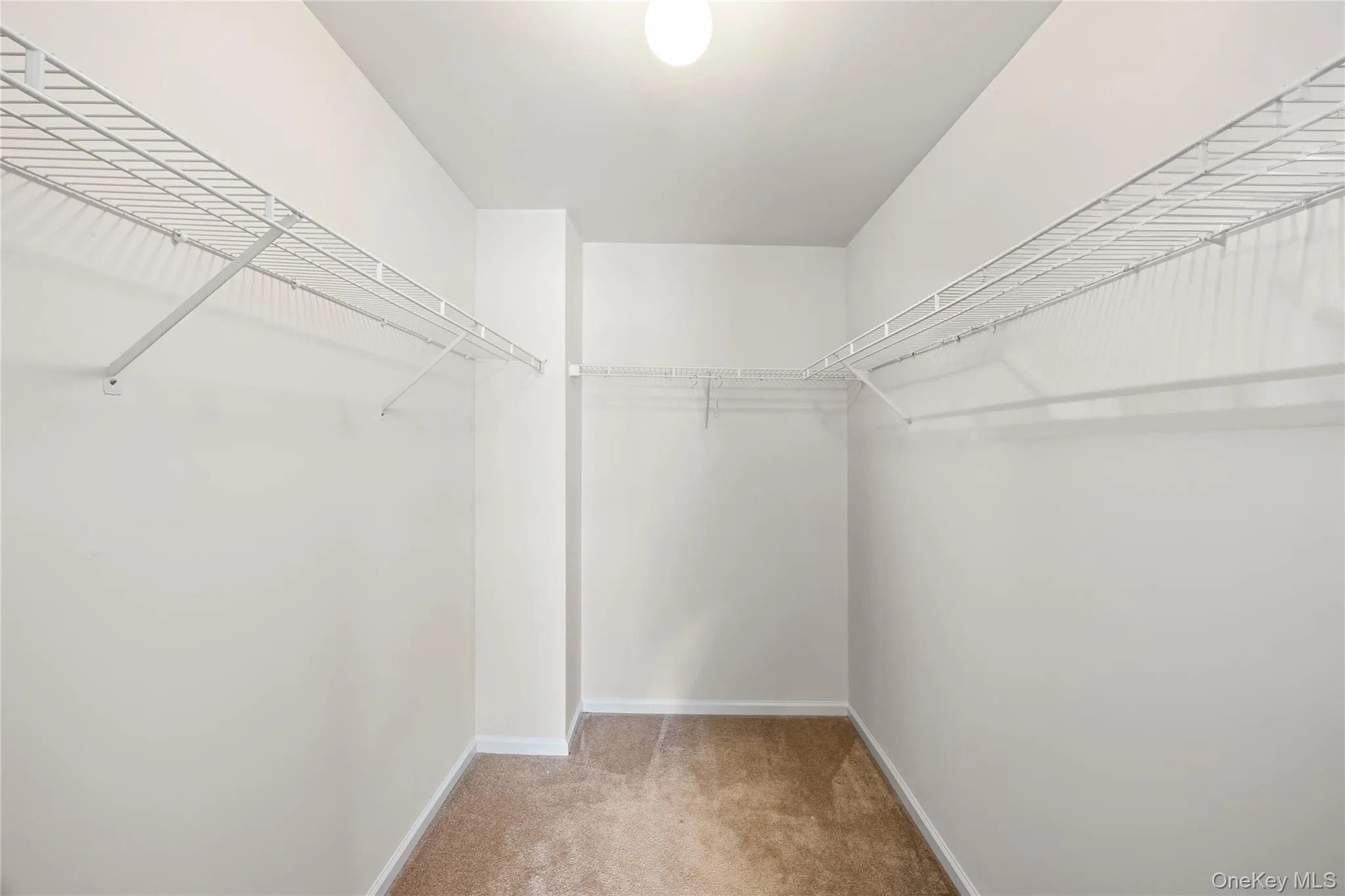 Walk in closet in primary bedroom Walk in closet in primary bedroom