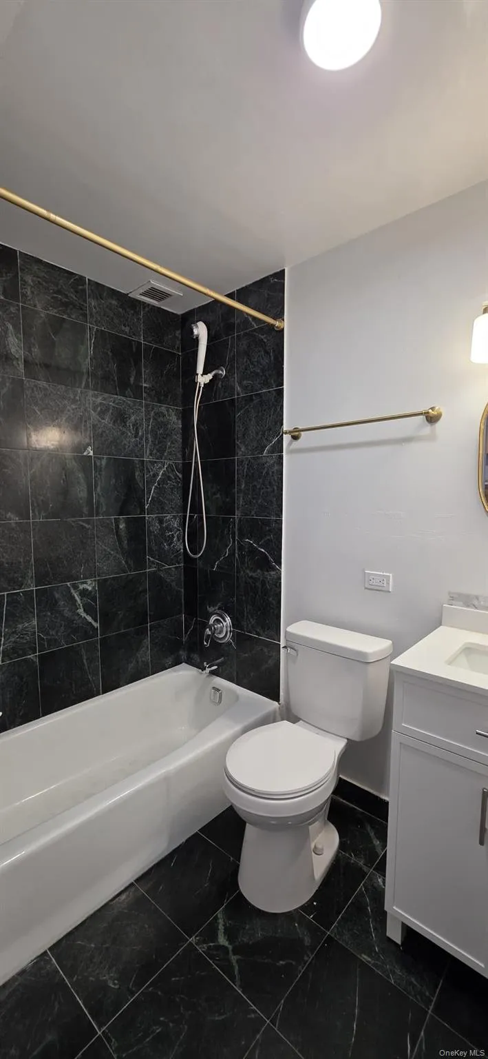 Common bathroom with soaking tub and shower head. Common bathroom with soaking tub and shower head.