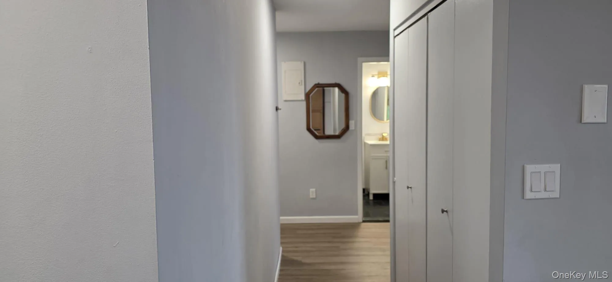 Hallway from kitchen to entry, bathroom, and bedrooms. Hallway from kitchen to entry, bathroom, and bedrooms.