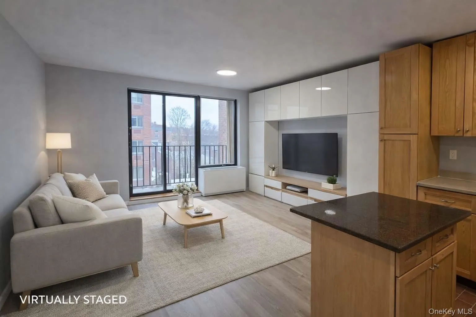 Livingroom, Kitchen island and balcony in the distance. Virtually staged. Livingroom, Kitchen island and balcony in the distance. Virtually staged.