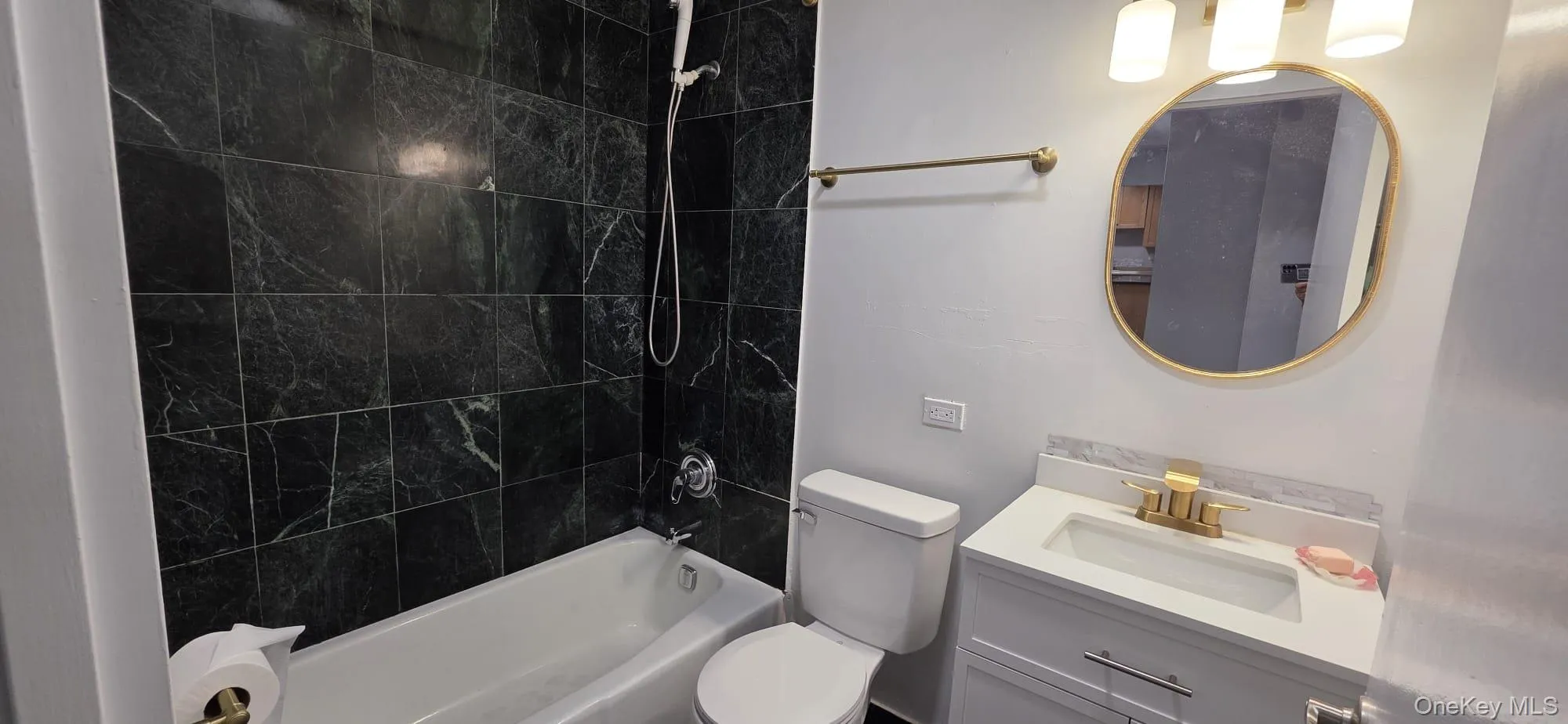 Common bathroom with soaking tub and shower head. Common bathroom with soaking tub and shower head.