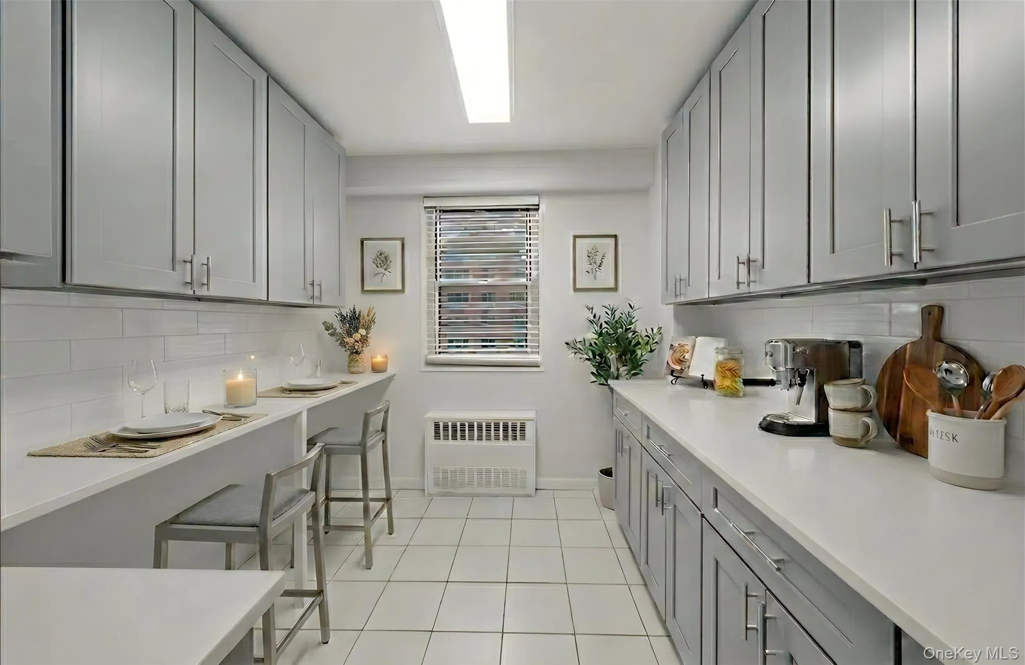 Staged eat-in kitchen with radiator heating unit and light tile patterned flooring Staged eat-in kitchen with radiator heating unit and light tile patterned flooring