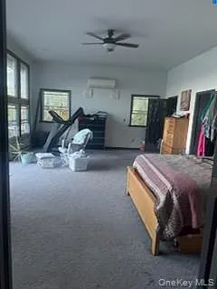 Carpeted bedroom featuring ceiling fan Carpeted bedroom featuring ceiling fan