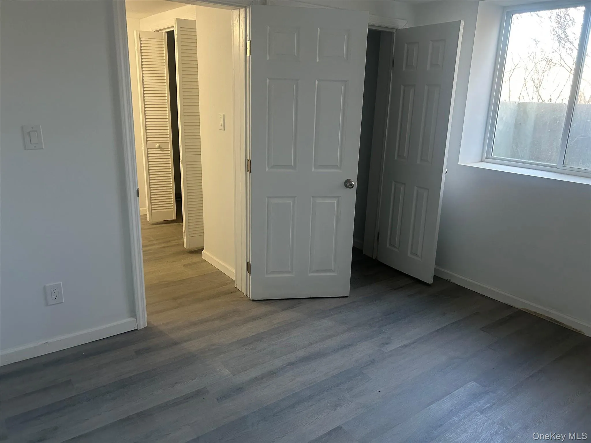 Unfurnished bedroom featuring wood finished floors and baseboards Unfurnished bedroom featuring wood finished floors and baseboards