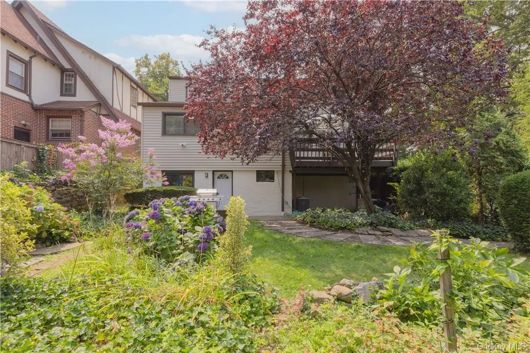 View of yard featuring a deck and central AC View of yard featuring a deck and central AC