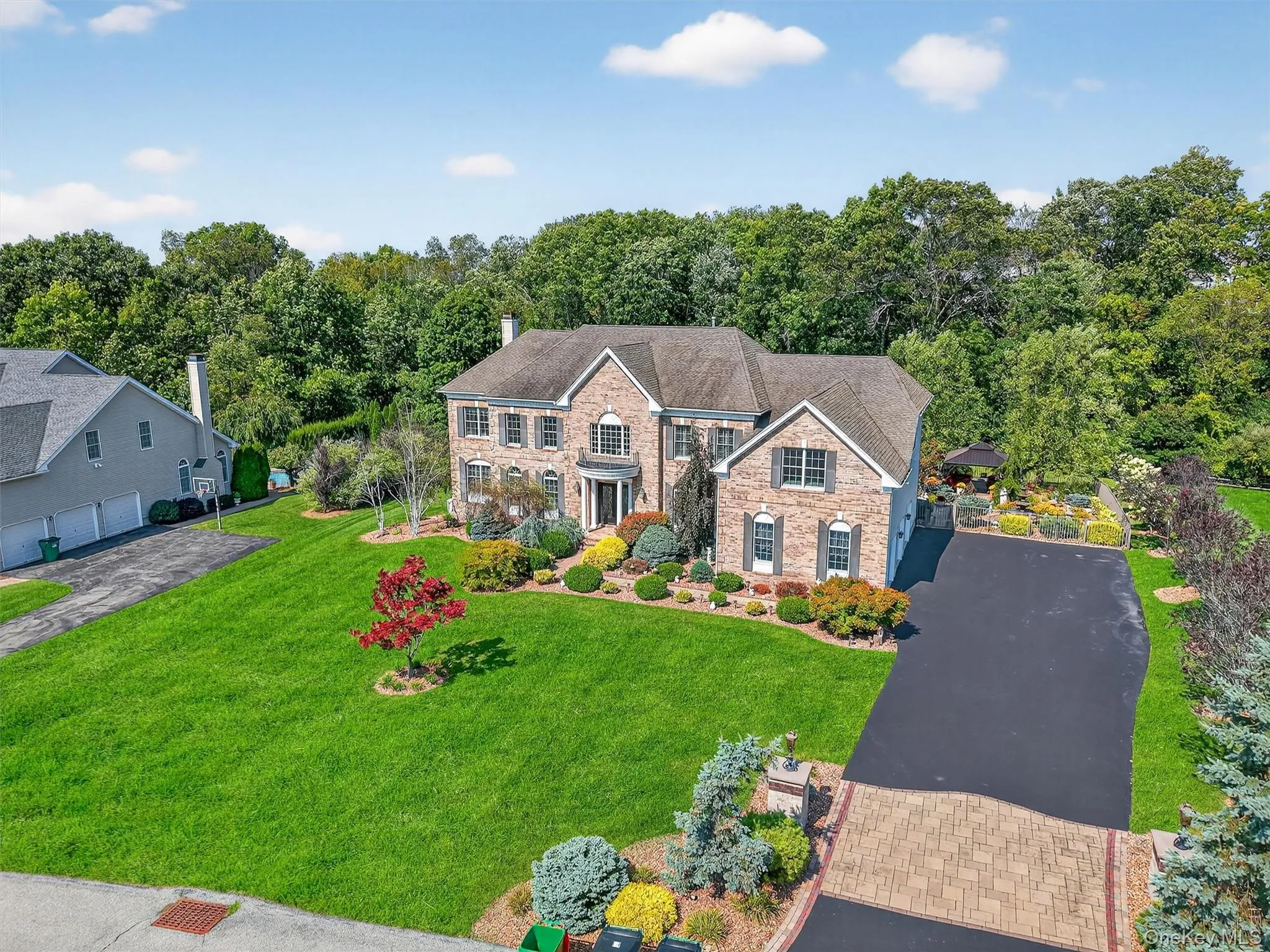 Welcome to your FOREVER home! A commuters dream, under 5 miles to Metro North train just 75 miles from Manhattan, this magnificent custom Colonial stands as the crown jewel of the community. The property welcomes you with an expansive driveway graced by an elegant stone apron, making a distinct first impression as you arrive. Set on a glorious one-acre lot, every detail has been designed for luxury living and exceptional entertaining Welcome to your FOREVER home! A commuters dream, under 5 miles to Metro North train just 75 miles from Manhattan, this magnificent custom Colonial stands as the crown jewel of the community. The property welcomes you with an expansive driveway graced by an elegant stone apron, making a distinct first impression as you arrive. Set on a glorious one-acre lot, every detail has been designed for luxury living and exceptional entertaining