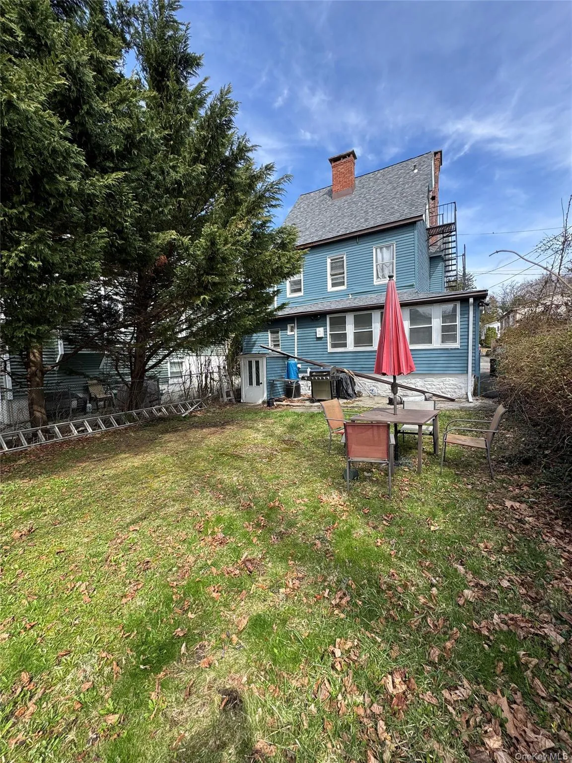 Rear view of property featuring a chimney. Rear view of property featuring a chimney.