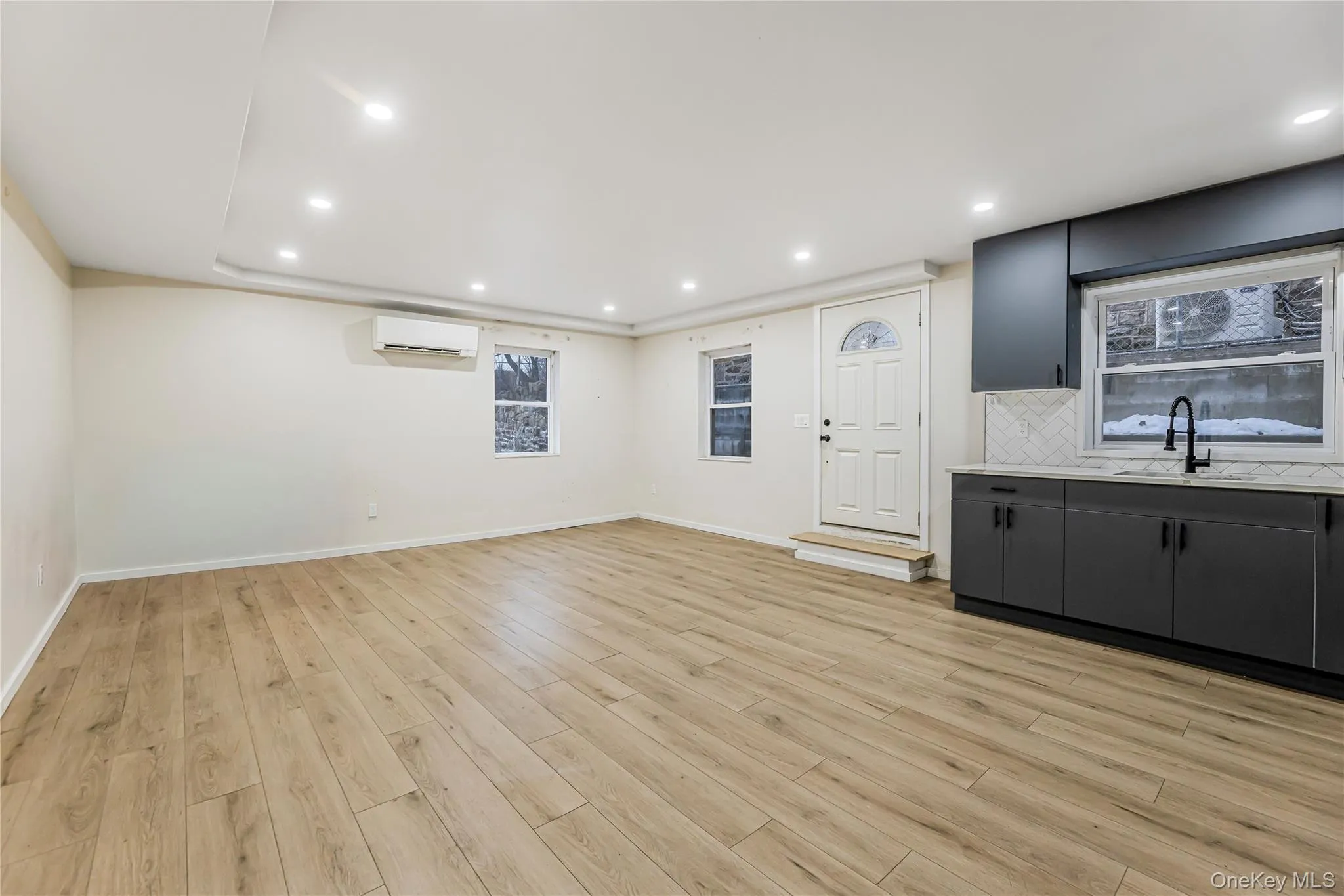 Alternate view of living area and kitchen Alternate view of living area and kitchen