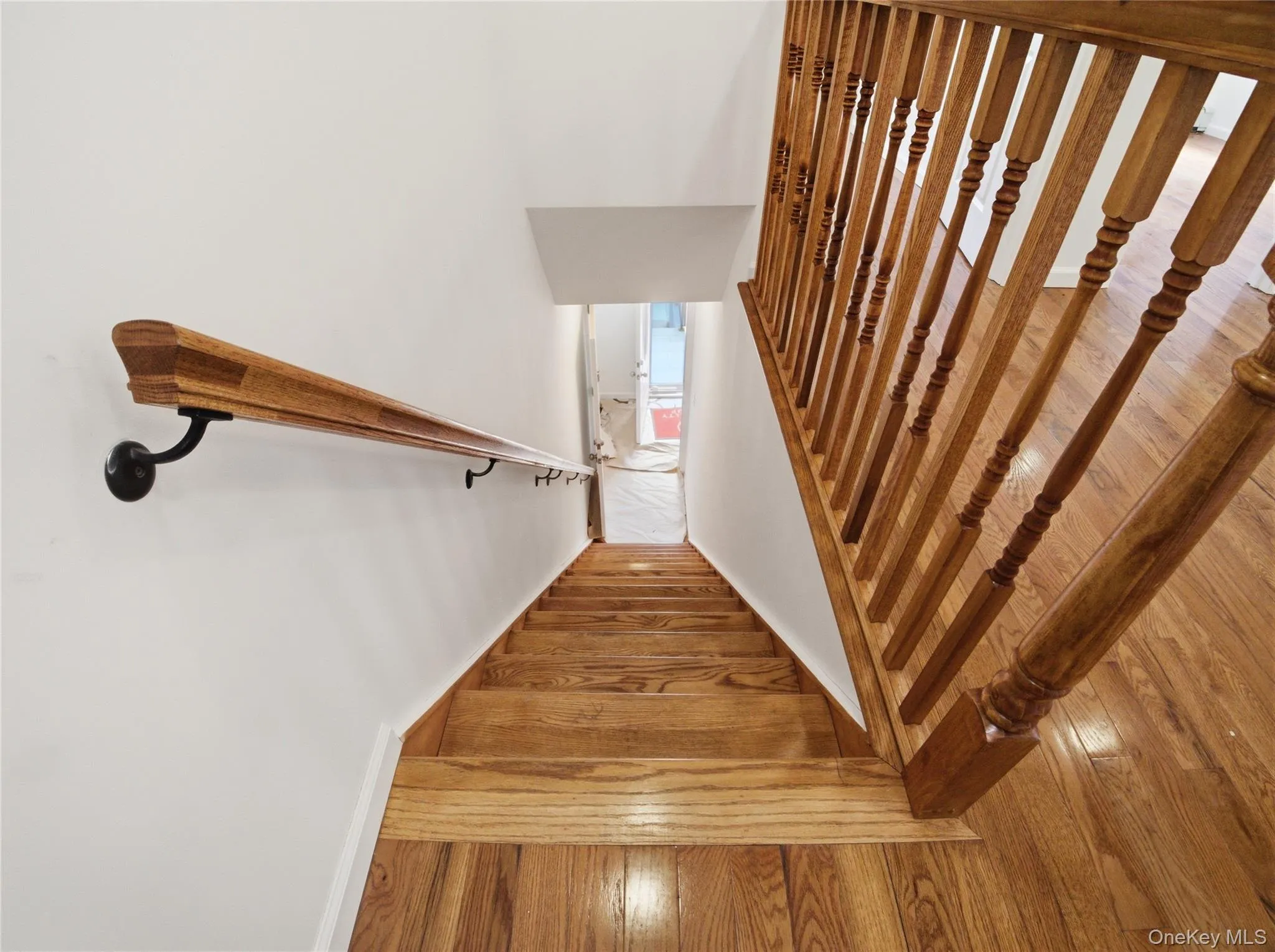 Stairs featuring hardwood / wood-style flooring Stairs featuring hardwood / wood-style flooring