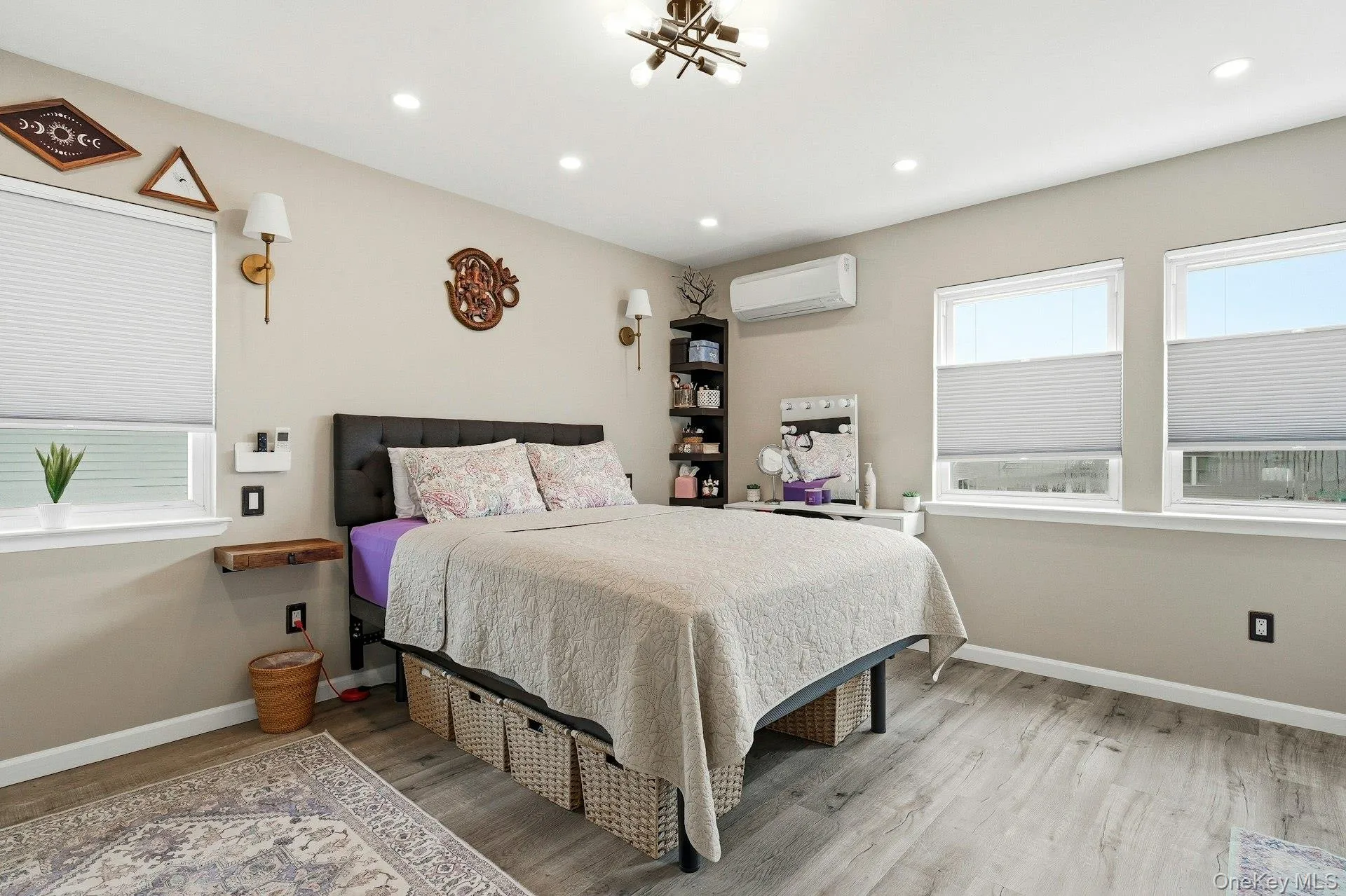 Bedroom with light wood-style floors and a chandelier overlooking water wth full Bth Bedroom with light wood-style floors and a chandelier overlooking water wth full Bth