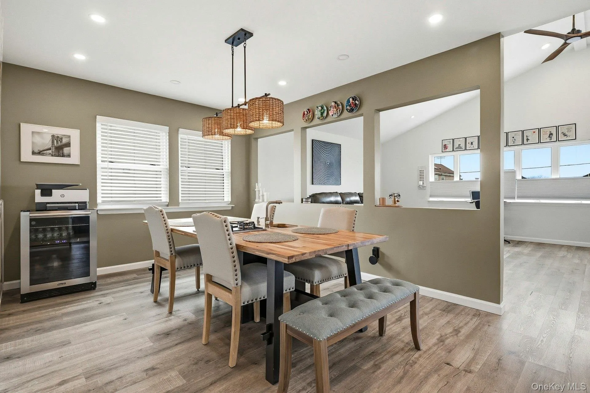 Dining space with wine cooler, vaulted ceiling, light wood-style flooring, plenty of natural light, and recessed lighting Dining space with wine cooler, vaulted ceiling, light wood-style flooring, plenty of natural light, and recessed lighting