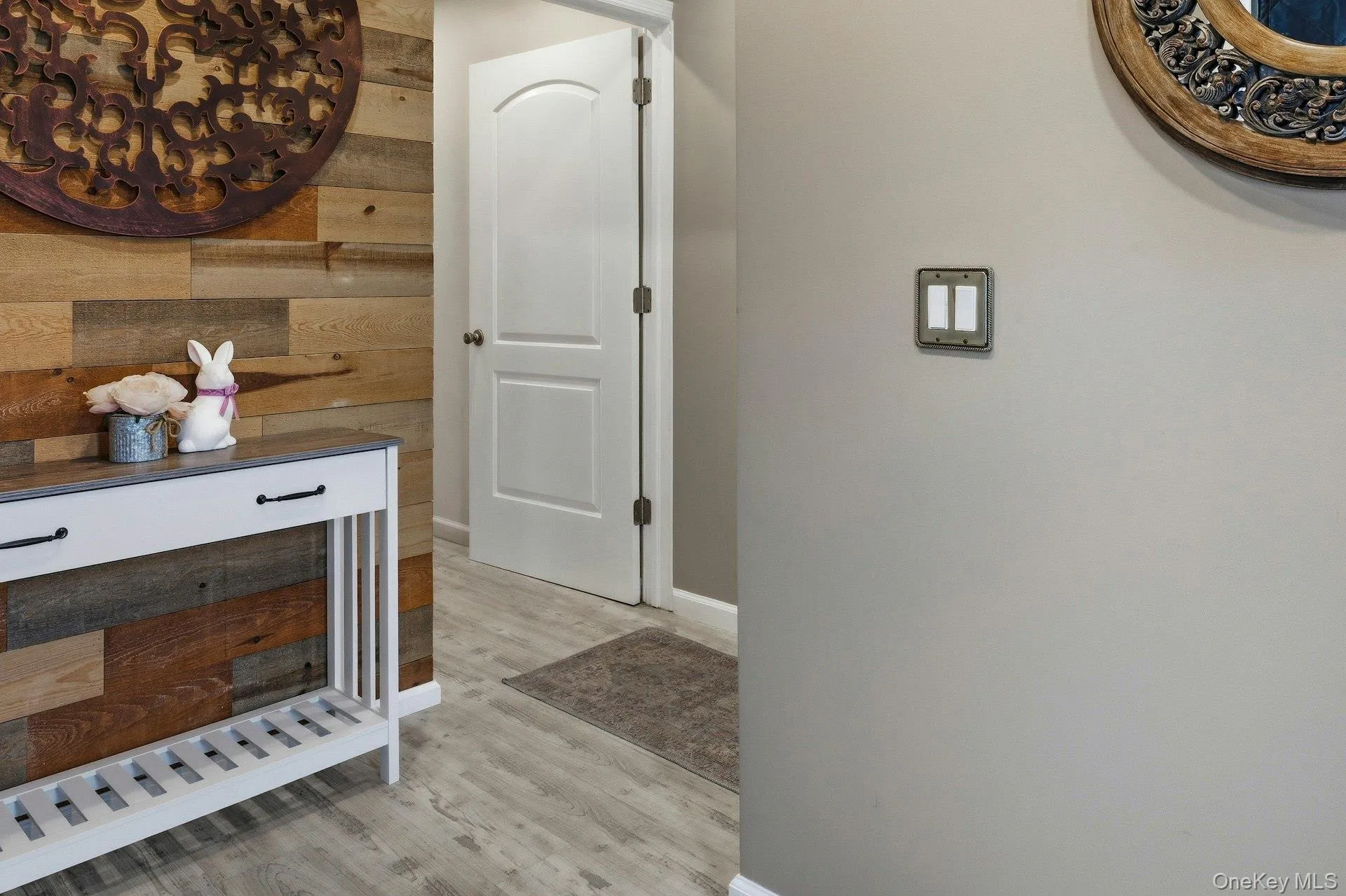 Hallway with light wood finished floors and shiplap feature wall Hallway with light wood finished floors and shiplap feature wall