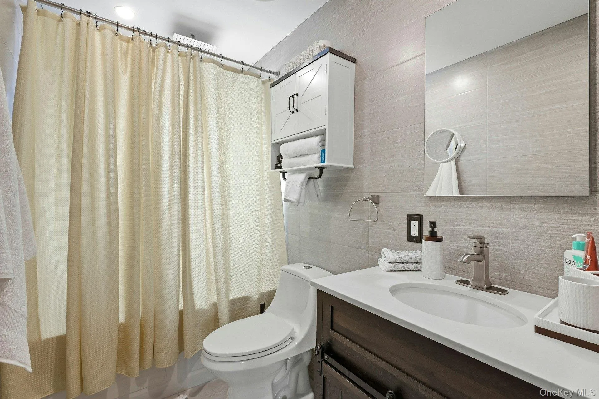 Full bathroom featuring vanity, tile walls, and shower wth Rain head/ Jacuzzi tub Full bathroom featuring vanity, tile walls, and shower wth Rain head/ Jacuzzi tub