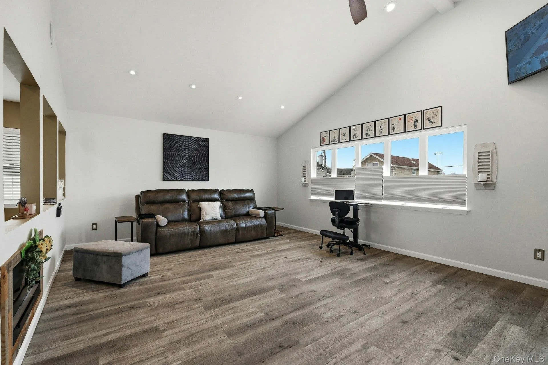 Living room featuring recessed lighting, lofted ceiling, wood finished floors, and ceiling fan Living room featuring recessed lighting, lofted ceiling, wood finished floors, and ceiling fan