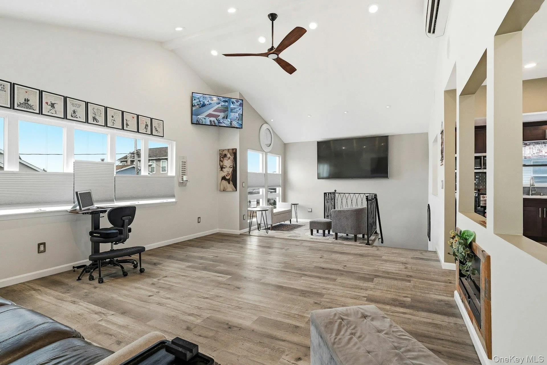 Living area with a ceiling fan, light wood-style floors, lofted ceiling, healthy amount of natural light, and recessed lighting Living area with a ceiling fan, light wood-style floors, lofted ceiling, healthy amount of natural light, and recessed lighting