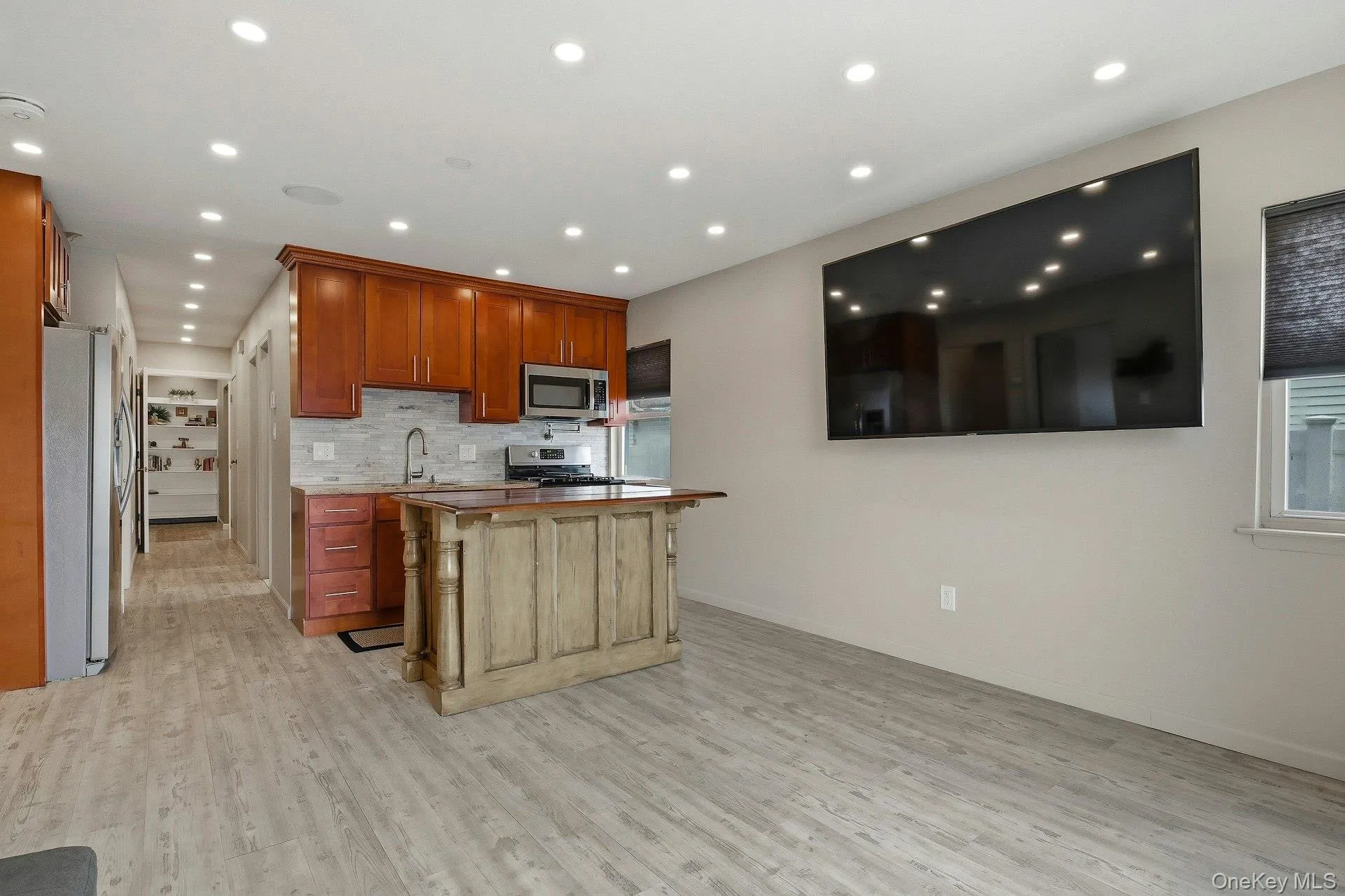 Kitchen with stainless steel appliances, wooden counters, tasteful backsplash, light wood-style floors, and recessed lighting Kitchen with stainless steel appliances, wooden counters, tasteful backsplash, light wood-style floors, and recessed lighting