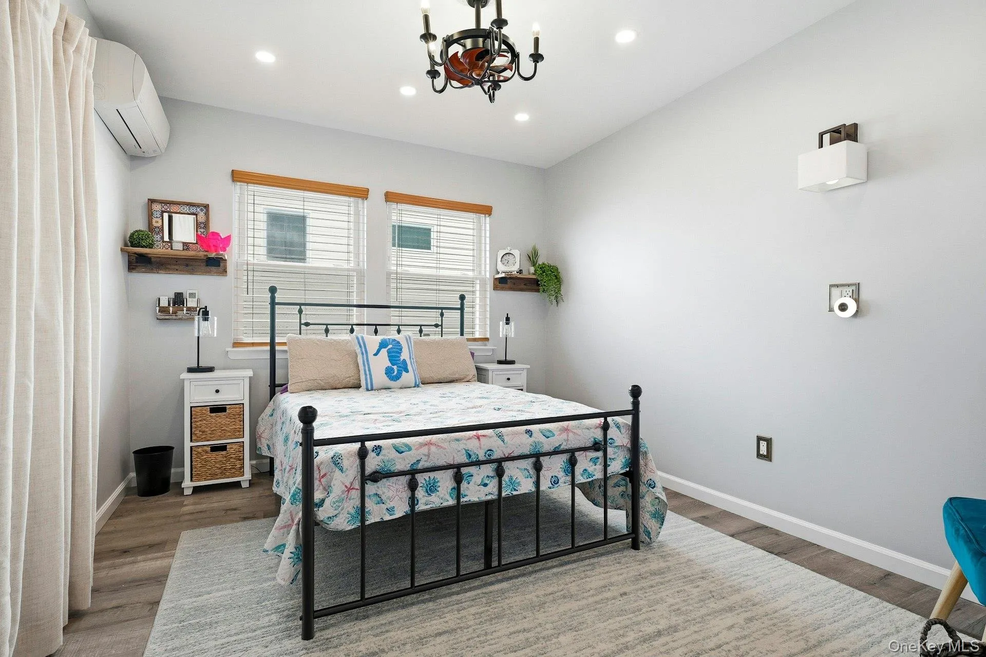 Bedroom with hanging lights,spacious closet and light wood-style floors Bedroom with hanging lights,spacious closet and light wood-style floors