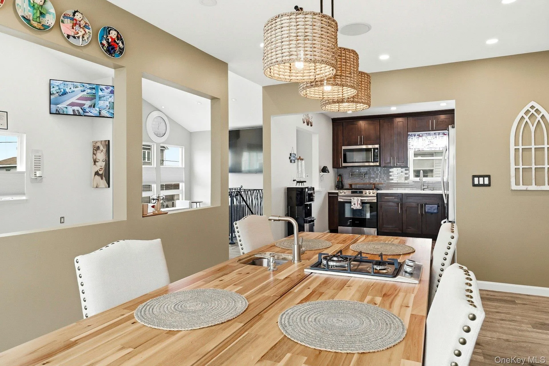 Dining area featuring lofted ceiling, light wood-style flooring, and hanging lights Dining area featuring lofted ceiling, light wood-style flooring, and hanging lights