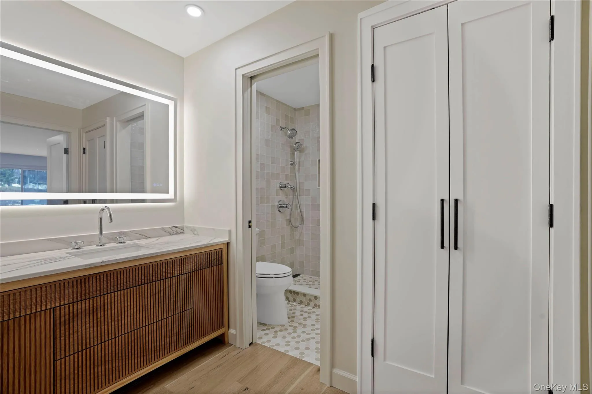 Beautiful new vanity and mirror in this Total remodeledbathroom with walk in snower Beautiful new vanity and mirror in this Total remodeledbathroom with walk in snower