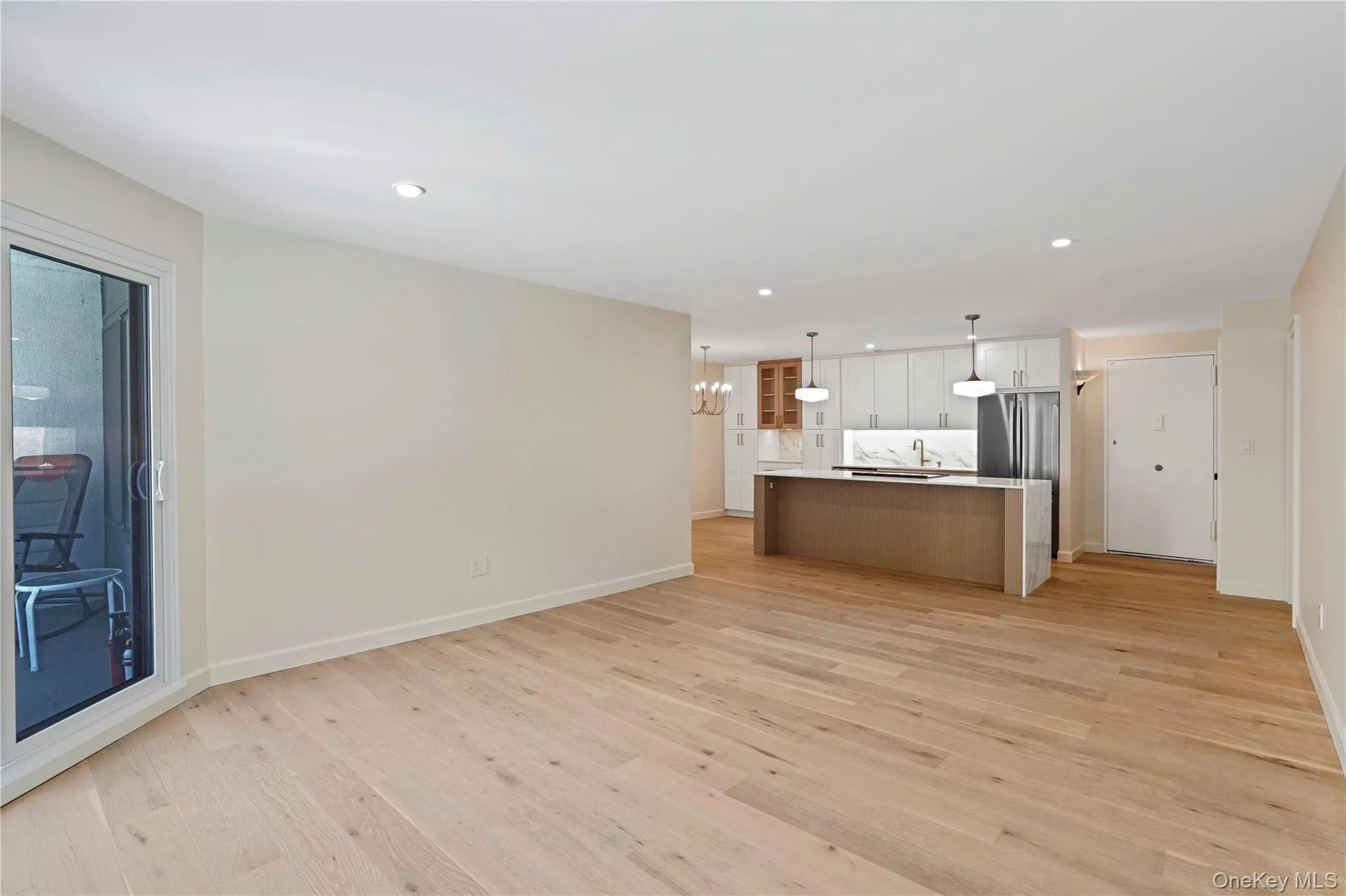 From the living room into the kitchen. White oak floors. From the living room into the kitchen. White oak floors.