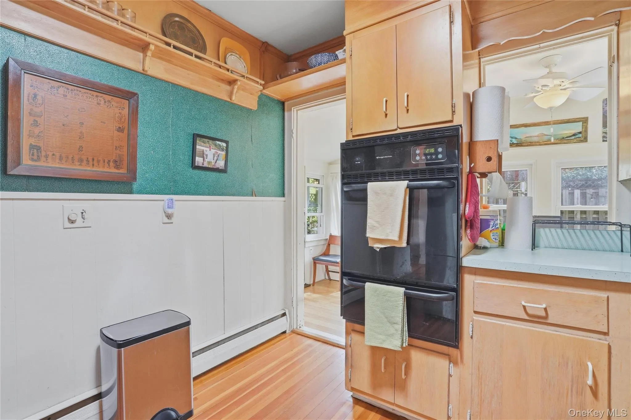 The kitchen features wood flooring, built-in double ovens, and wood cabinetry The kitchen features wood flooring, built-in double ovens, and wood cabinetry