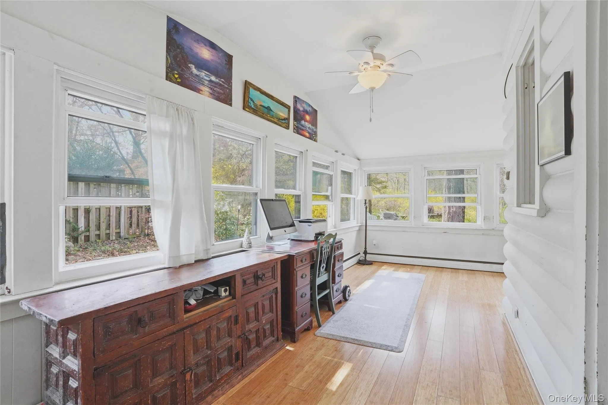 This bright porch features vaulted ceilings, hardwood floors, and numerous windows providing abundant natural light. This bright porch features vaulted ceilings, hardwood floors, and numerous windows providing abundant natural light.