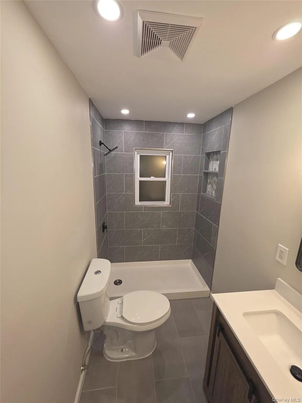 Renovated tiled bath with tub Renovated tiled bath with tub