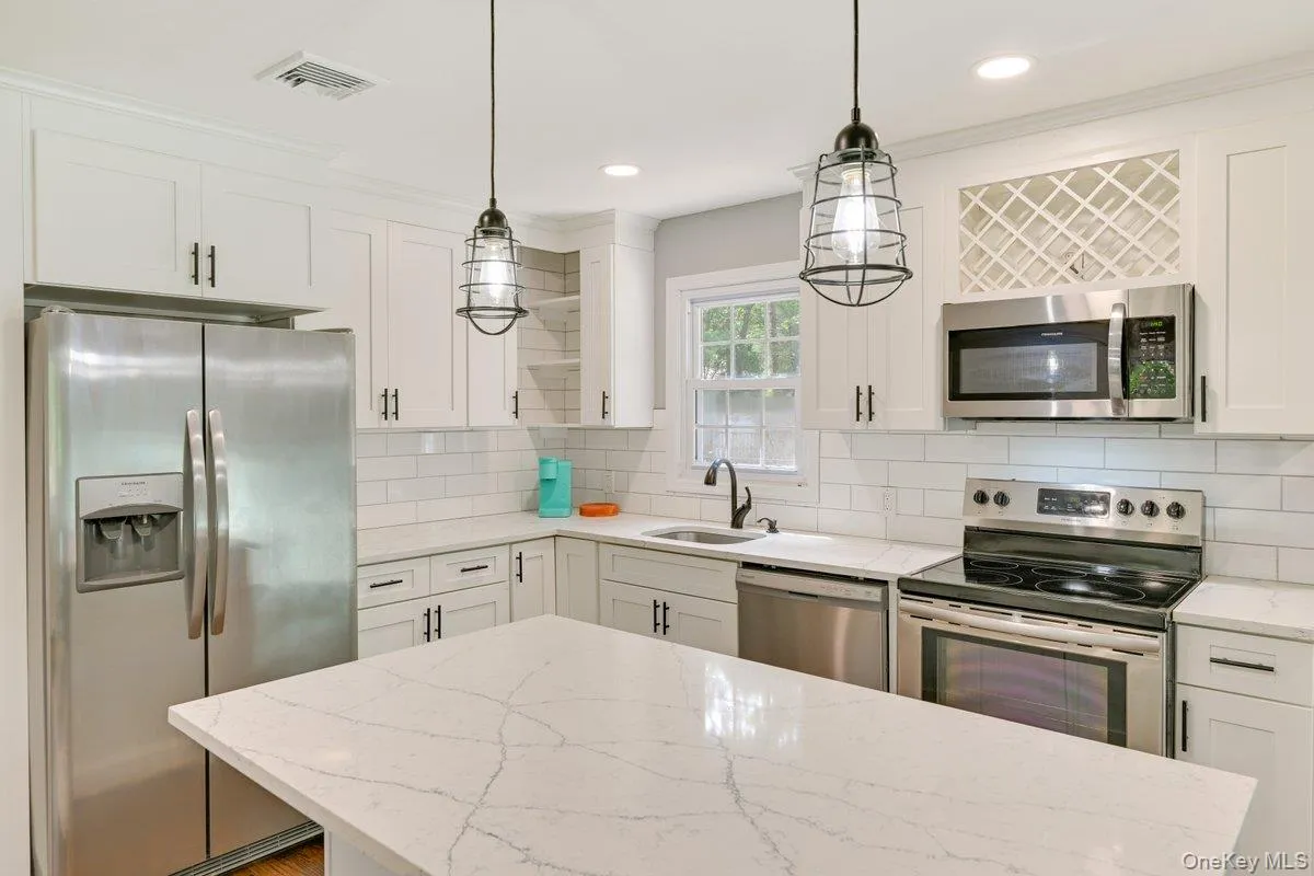 Recently update open kitchen with quartzite counters and stainless steel appliances Recently update open kitchen with quartzite counters and stainless steel appliances