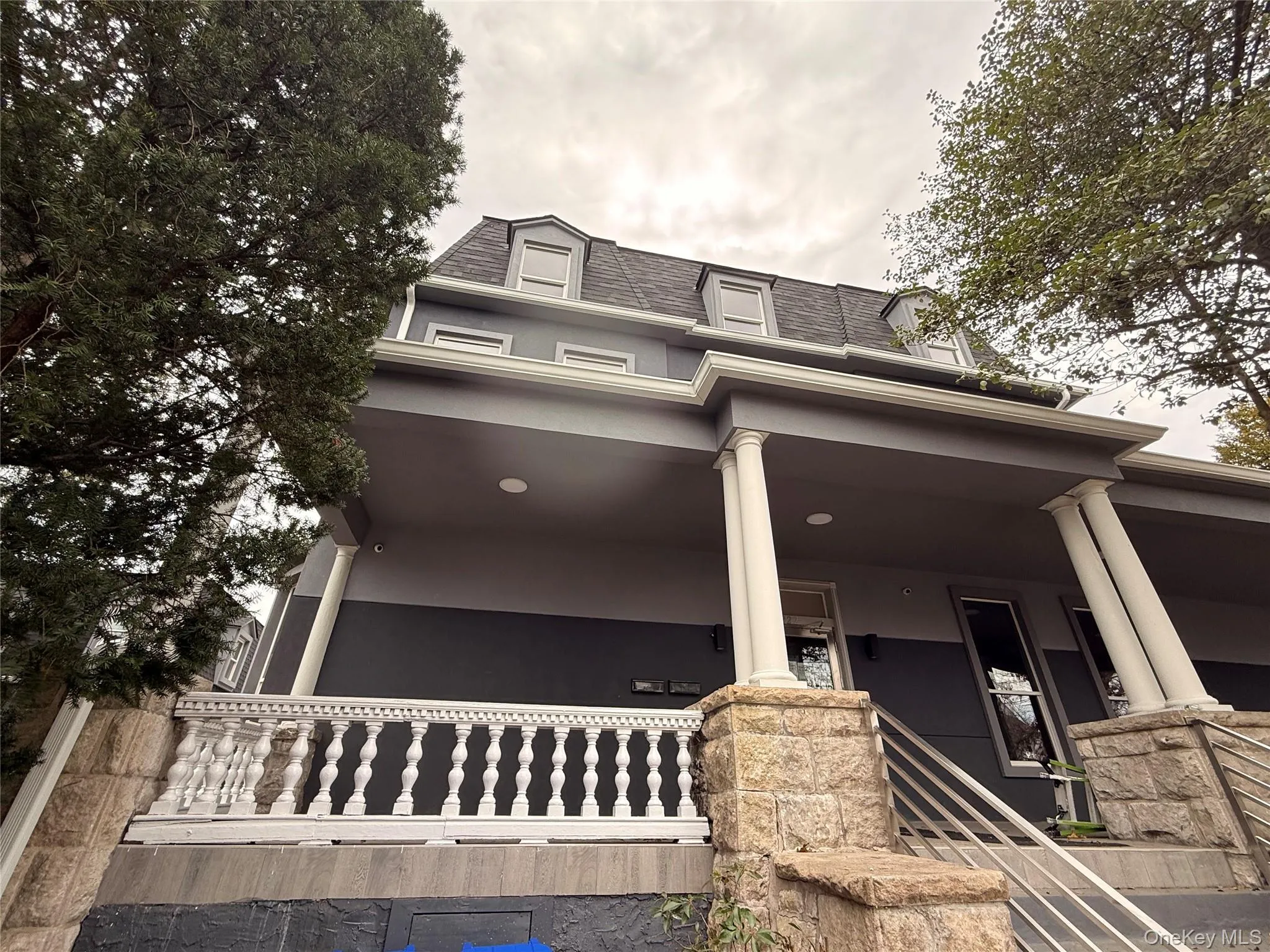 View of front of property featuring covered porch and mansard roof View of front of property featuring covered porch and mansard roof