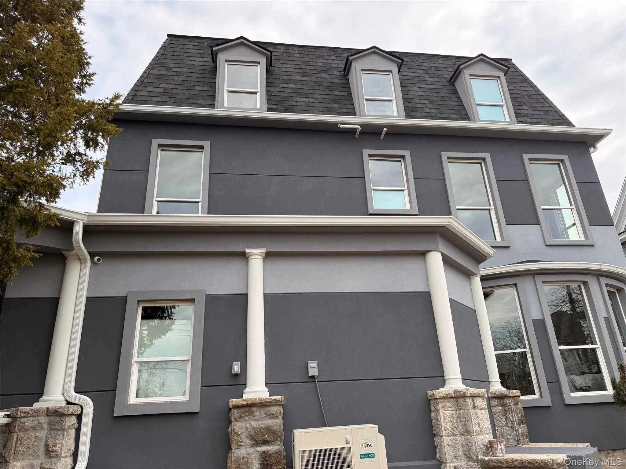 View of front facade featuring stucco siding and roof with shingles View of front facade featuring stucco siding and roof with shingles