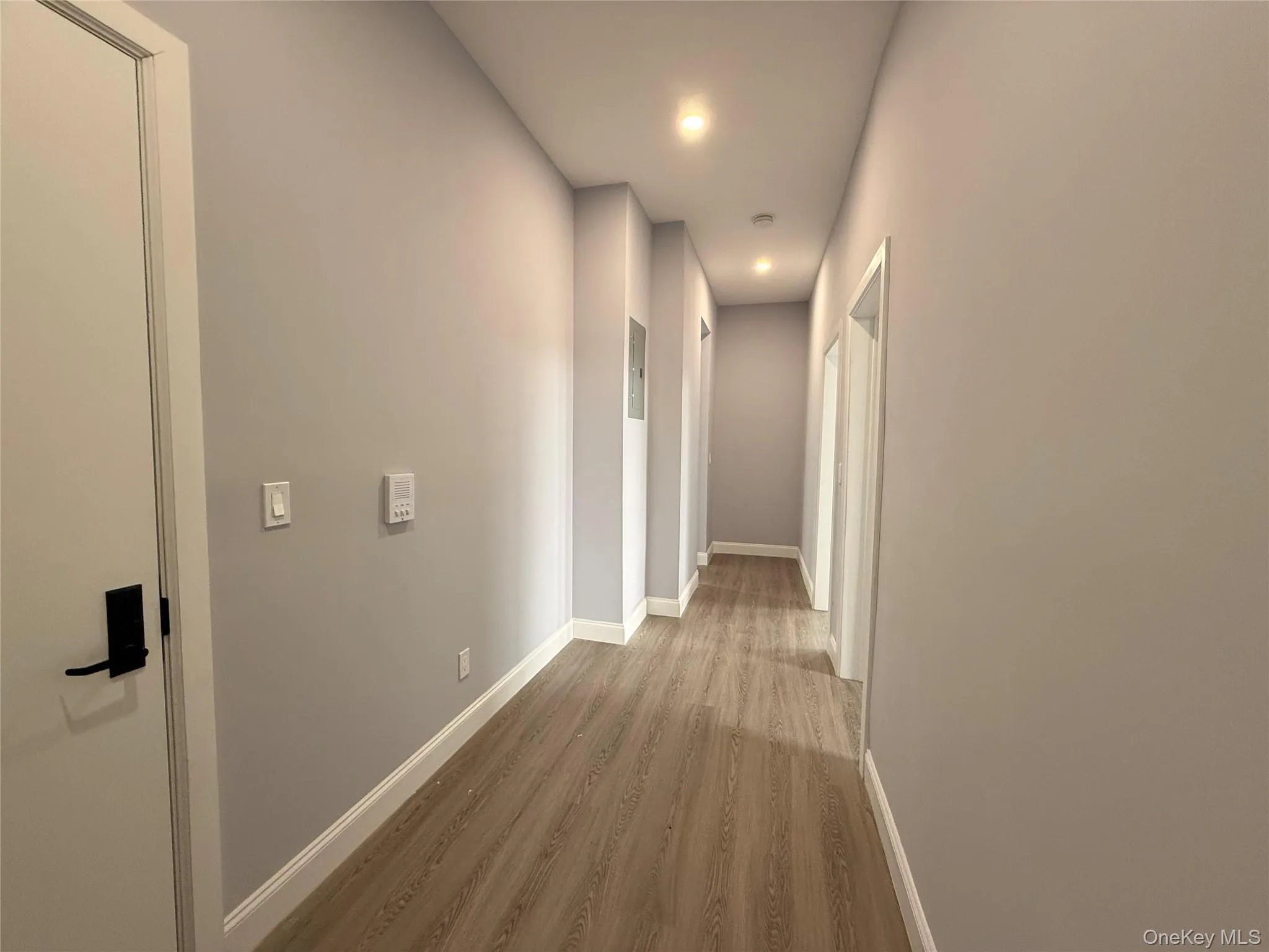 Corridor featuring light wood-style floors and recessed lighting Corridor featuring light wood-style floors and recessed lighting