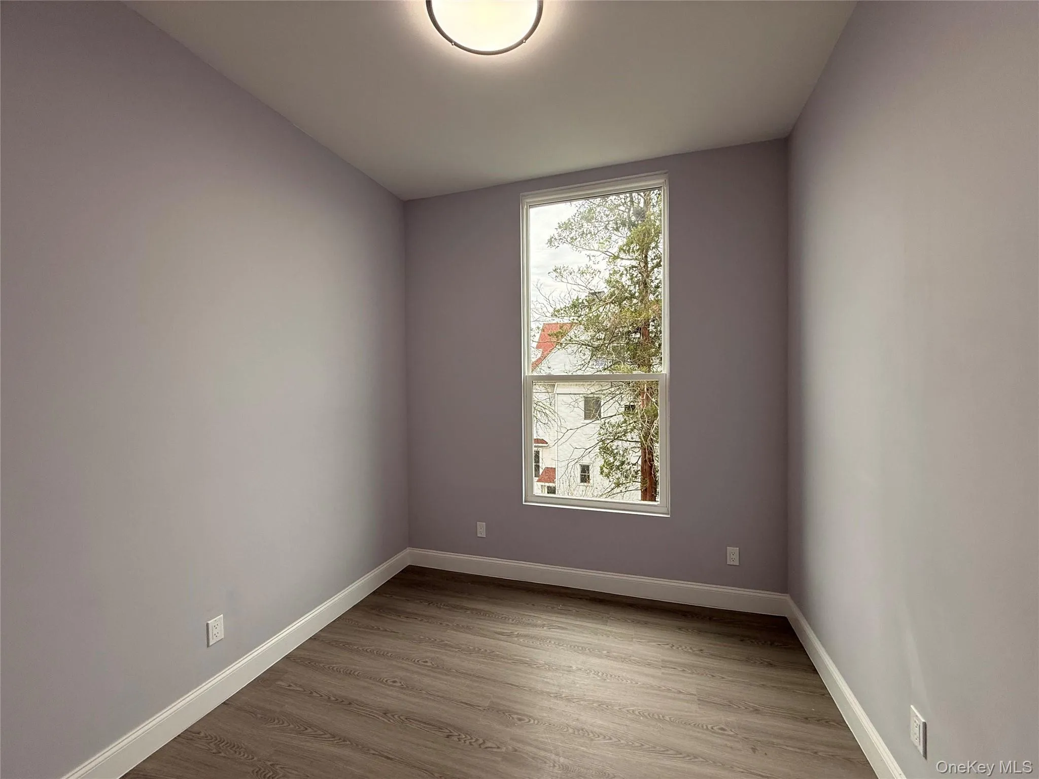 Bedroom #1 with light wood-style floors and baseboards Bedroom #1 with light wood-style floors and baseboards