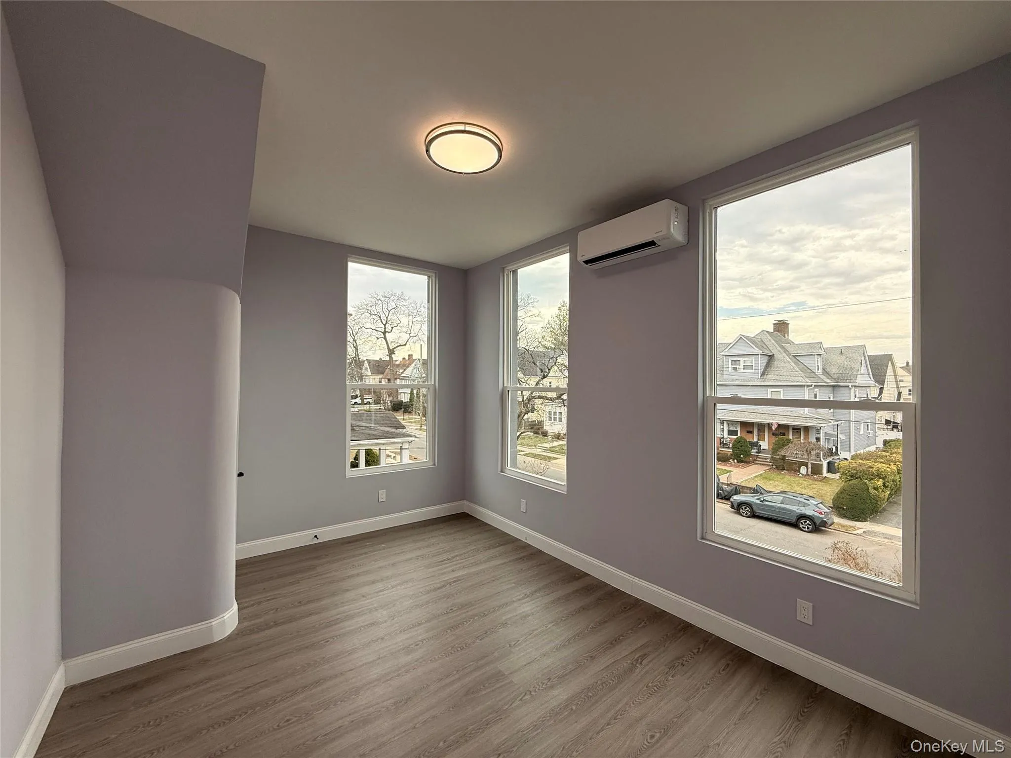 Bedroom #5 with wood finished floors and a mini split for heating / cooling Bedroom #5 with wood finished floors and a mini split for heating / cooling