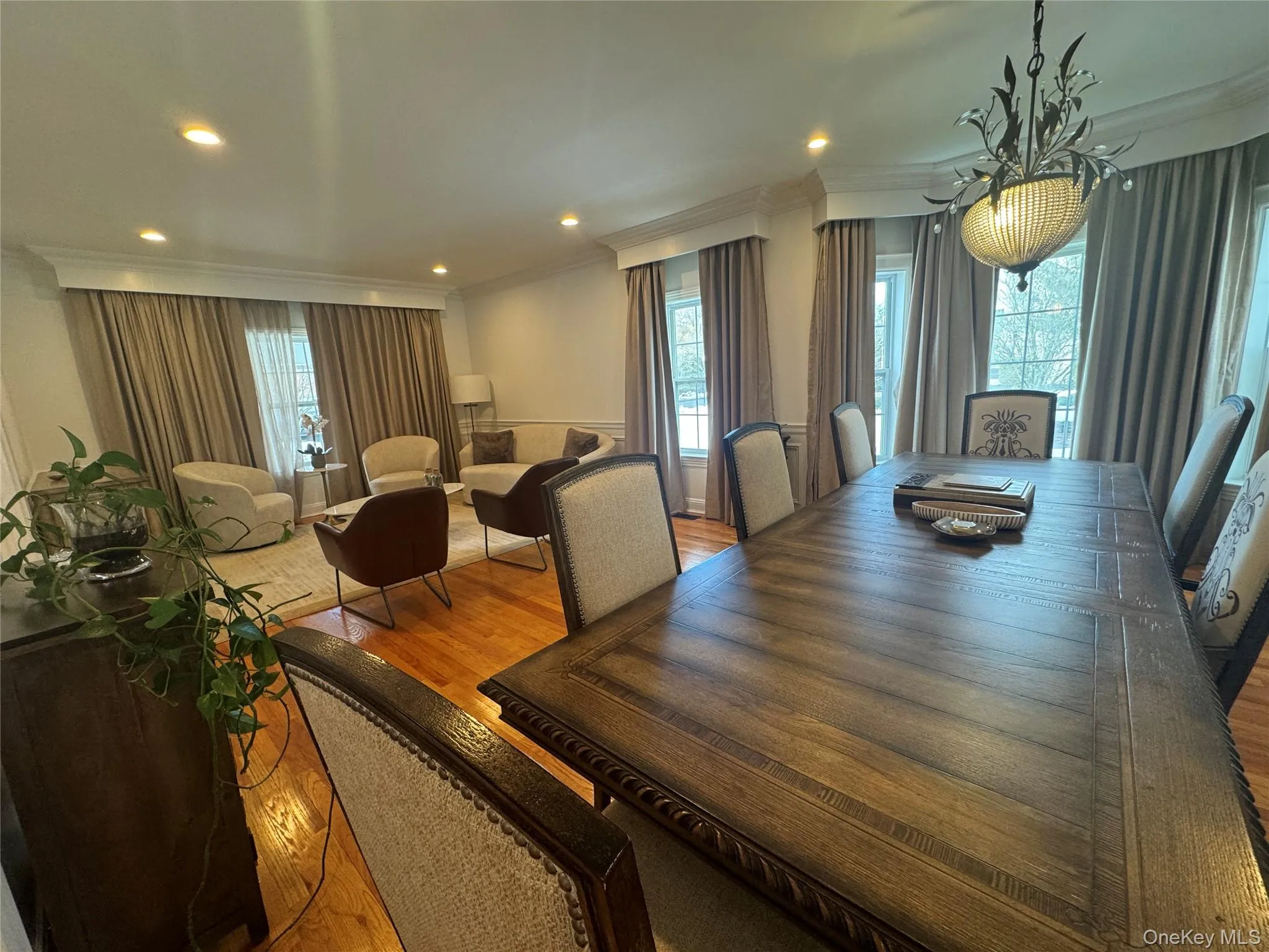 Dining area featuring crown molding, wood finished floors, and recessed lighting Dining area featuring crown molding, wood finished floors, and recessed lighting
