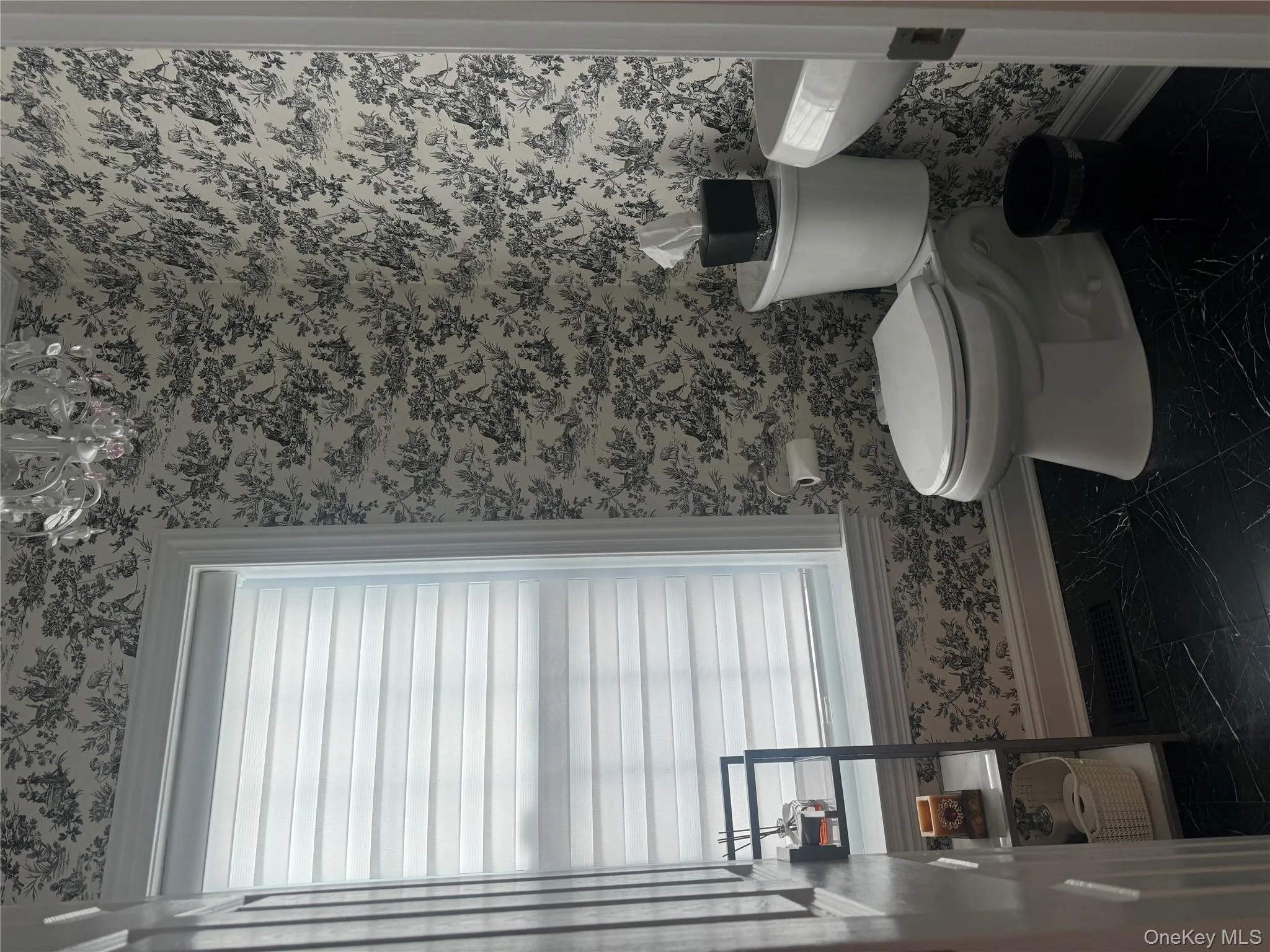 Bathroom with baseboards and wallpapered walls Bathroom with baseboards and wallpapered walls