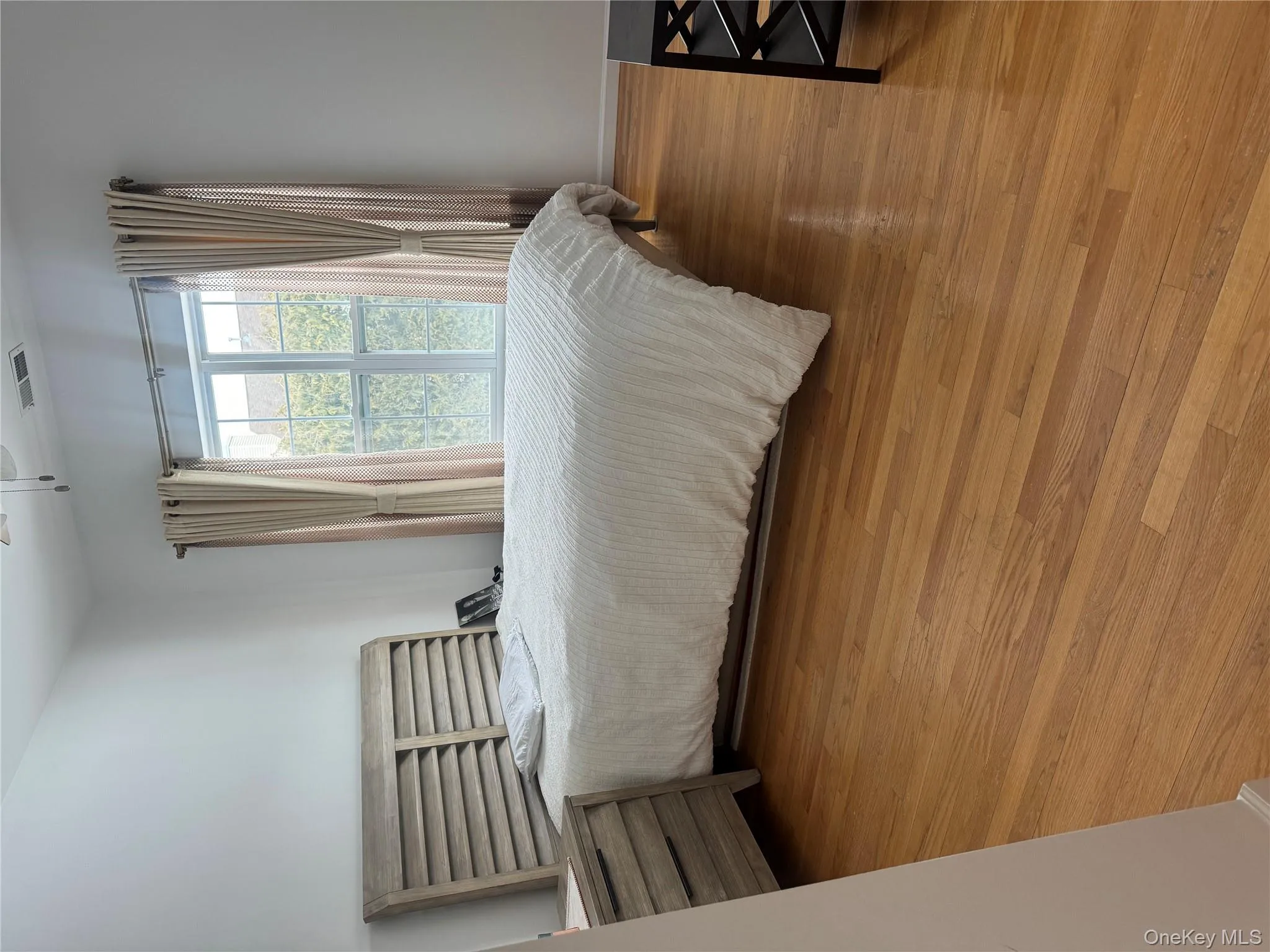 Bedroom with wood finished floors and a ceiling fan Bedroom with wood finished floors and a ceiling fan
