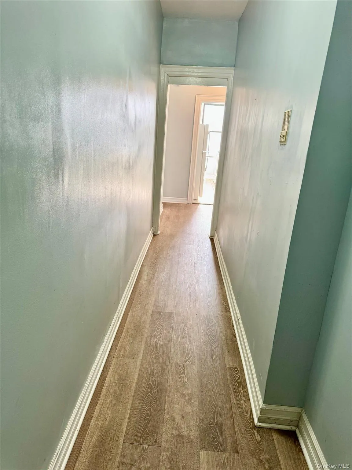Corridor with wood finished floors and baseboards Corridor with wood finished floors and baseboards