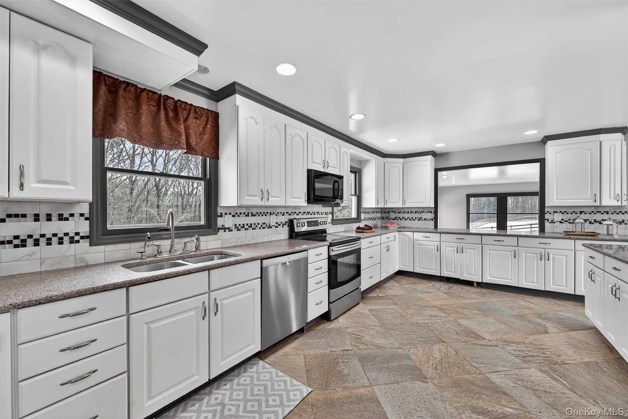 The kitchen has plenty of Norcraft soft-close cabinets and scads of counter space. The kitchen has plenty of Norcraft soft-close cabinets and scads of counter space.