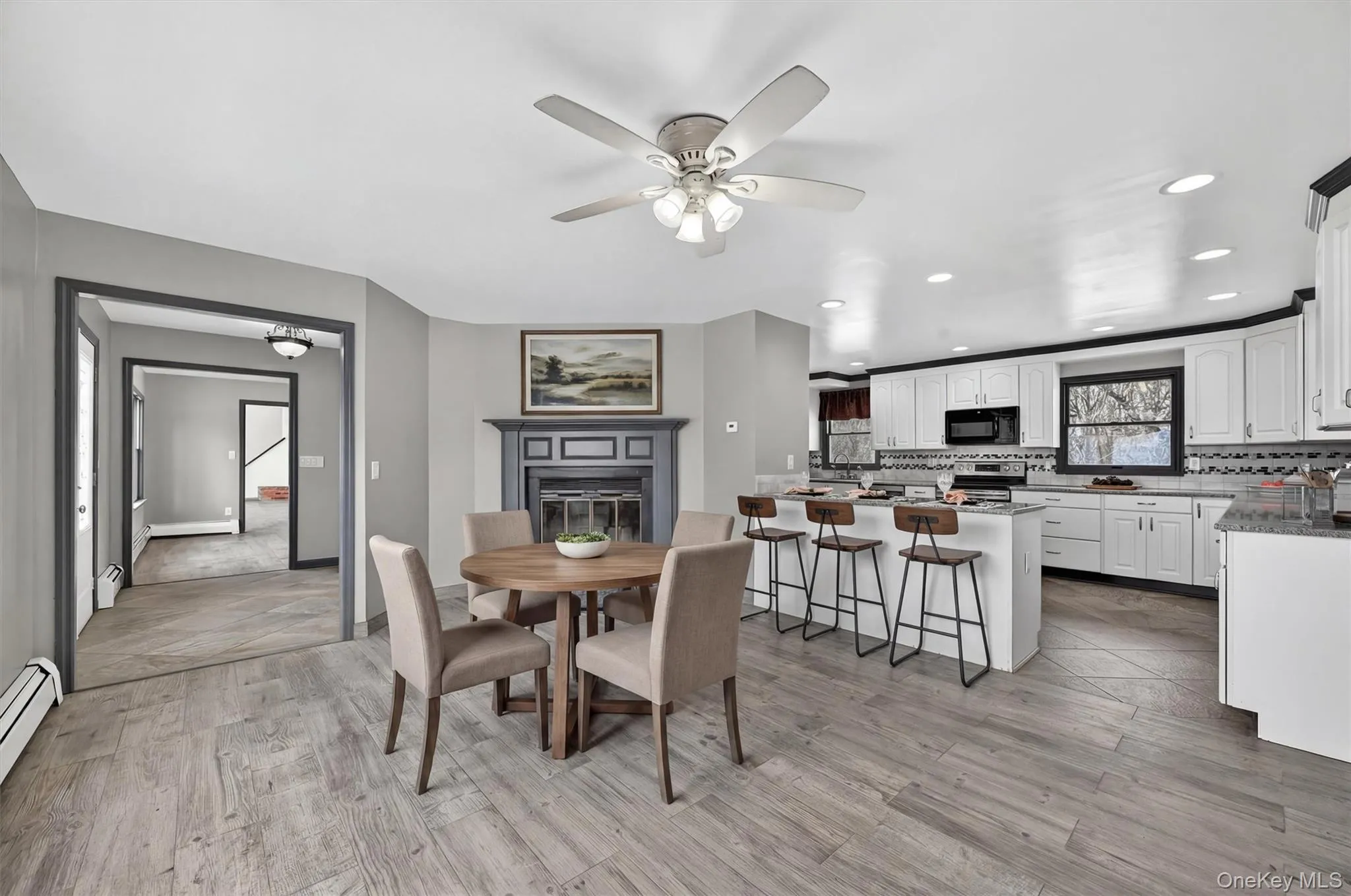Cozy breakfast nook features a fireplace and windows overlooking farmVirtually Staged Cozy breakfast nook features a fireplace and windows overlooking farmVirtually Staged